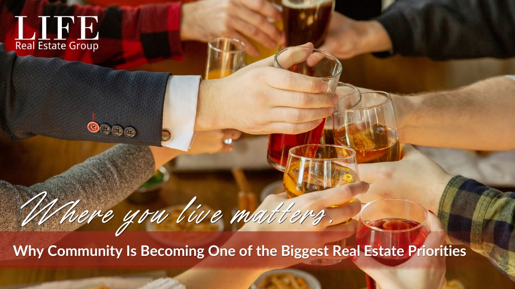 Friends and neighbours raising glasses together, representing the importance of community when choosing where to live.